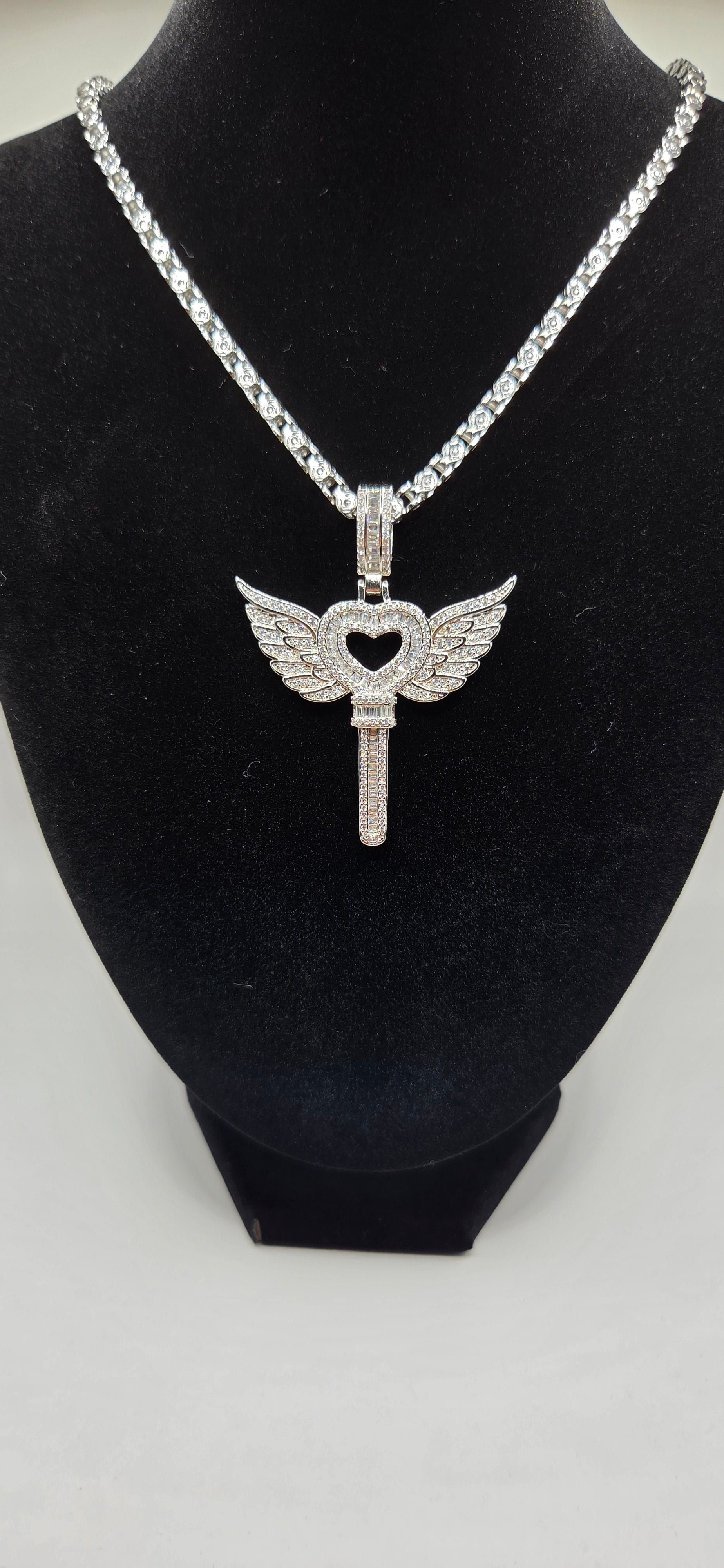 Iced out heart key with wings pendant with 24 inch silver/gold rope chain